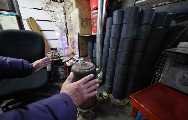 1일 서울 서대문구 홍제동 개미마을에서 한 주민이 연탄보일러로 추위를 녹이고 있다. 2023.2.1. 연합뉴스