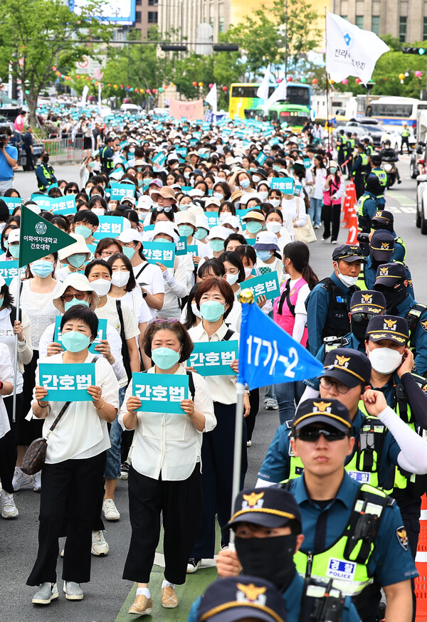 대한간호협회 회원들이 19일 서울 종로구 세종대로에서 서울역 방향으로 간호법 거부권 행사 규탄 행진을 하고 있다. 2023.5.19. 연합뉴스