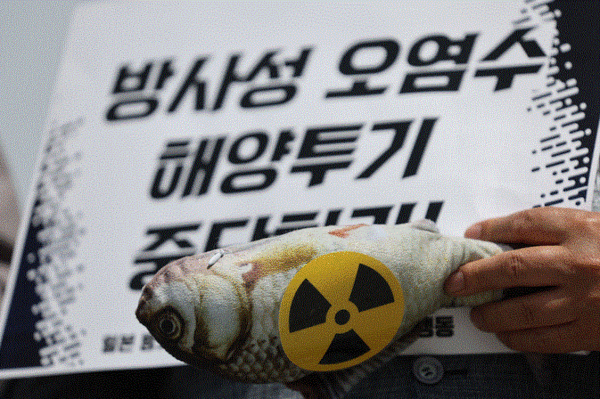 지난 5월 17일 서울 광화문광장에서 일본 방사성 오염수 해양투기 저지 공동행동 주최로 열린 히로시마 G7 정상회의 대응 기자 회견에서 한 참가자가 ‘방사성 오염수 해양 투기 중단하라’는 손팻말을 들고 있다. 연합뉴스