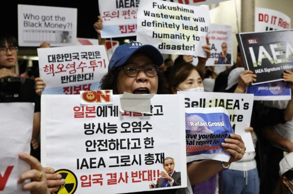 7일 김포공항 국제선 입국장 인근에서 시민들이 라파엘 그로시 국제원자력기구(IAEA) 사무총장의 방한을 반대하는 손 피켓을 들고 있다. 연합뉴스