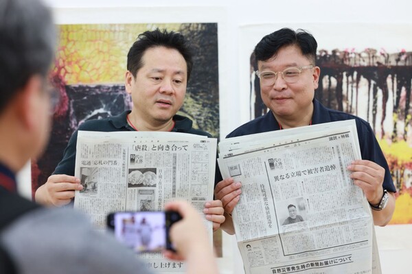 일본 현지에서 보도된 '아이고展(전)'에 대한 신문을 들고 있는 고경일 교수와 아트만두 작가. 2023.8.16. 이호 사진 작가