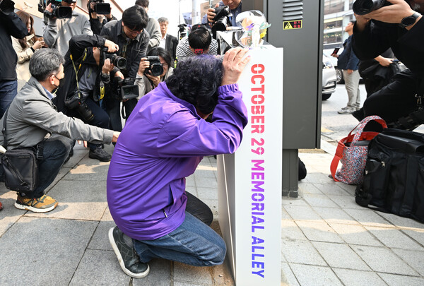 26일 서울 용산구 이태원역 1번 출구 앞에서 열린 '10.29 기억과 안전의 길' 조성 기자회견에 참석한 이태원 참사 유가족들이 설치된 조형물을 어루만지고 있다. 2023.10.26. 연합뉴스