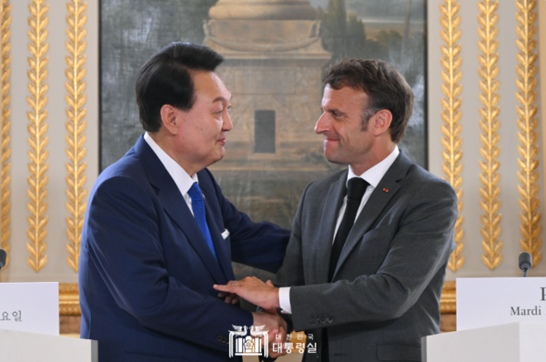 윤석열 대통령과 에마뉘엘 마크롱 대통령이 6월 20일 파리 엘리제궁에서 정상회담 공동기자회견을 한 뒤 서로 손을 맞잡고 있다. 윤 대통령은 이 자리에서  2030 부산엑스포 유치에 대한 프랑스의 지지를 당부하고 마크롱 대통령의 한국 방문을 제안했다. 두 정상은 11월 24일에도 회동했다. 2023.6.20. 대통령실 누리집