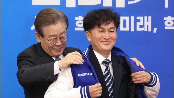 18일 국회에서 열린 더불어민주당 인재영입식에서 이재명 대표가 세번째 영입 인재인 류삼영 전 총경에게 당 점퍼를 입혀주고 있다. 2023.12.18. 연합뉴스
