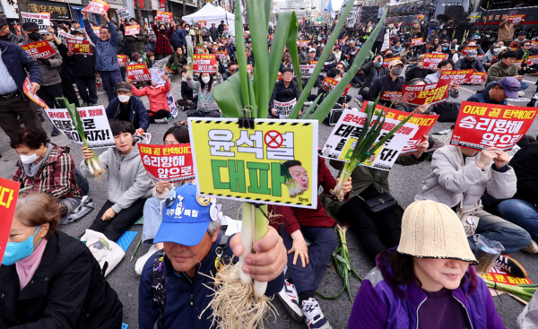 지난 3월 30일 오후 서울 시청역 인근 세종대로에서 열린 '83차 촛불 대행진' 집회에서 시민들이 대파를 들고 윤석열 정부 규탄 구호를 외치고 있다. 연합뉴스