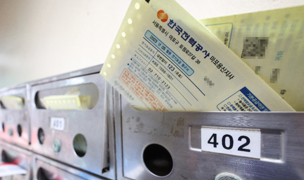 아파트 현관 수신함에 꽂혀있는 전기요금 징수 영수증。 연합뉴스