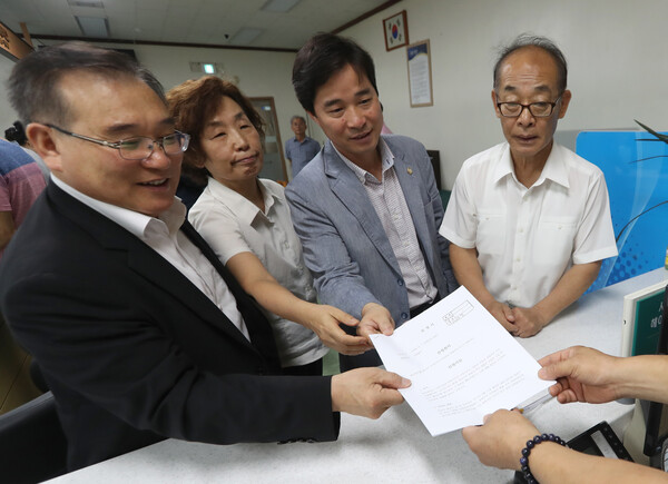 창원 마산합포구 오동동 '인권자주평화 다짐비'(평화의 소녀상)에 훼손이 잇따르자 인권자주평화다짐비 지키기 회원들이 31일 오전 마산중부경찰서 민원실에 수사를 촉구하는 진정서를 제출하고 있다. 왼쪽부터 김종대 창원시의회 부의장, 이경희 공동대표, 송순호 창원시 의원, 김영만 공동대표. 2017.7.31. 연합뉴스