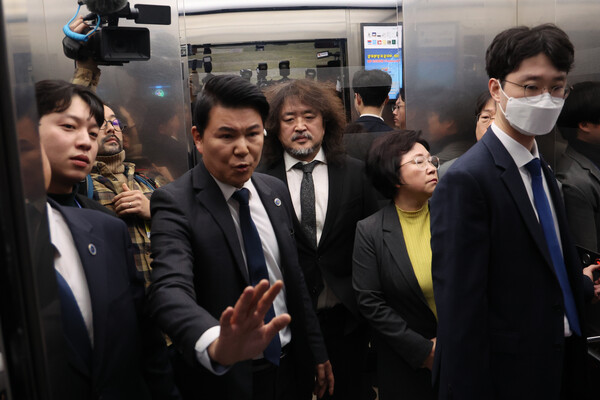 방송인 김어준씨가 13일 국회 과학기술정보방송통신위원회 전체회의에서 계엄 당시 암살조 가동 등 제보 내용을 밝힌 뒤 국회 경위들의 보호를 받으며 떠나고 있다. 2024.12.13. 연합뉴스