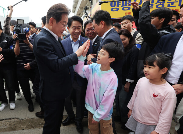 더불어민주당 이재명 대선 후보가 5일 경기도 양평군 양평물맑은시장에서 열린 '골목골목 경청투어'에서 어린이들과 인사하고 있다. 2025.5.5. 연합뉴스