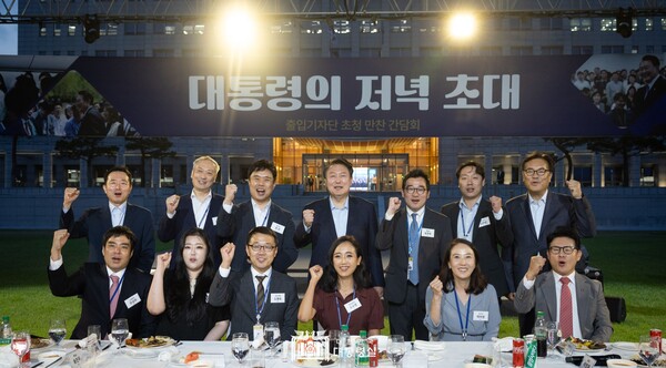 지난해 윤석열 대통령과 김치찌개, 계란말이, 소고기 만찬에 참석한 대통령실 출입기자들이 윤석열과 주먹을 불끈 쥐며 화이팅을 외치고 있는 모습. 대통령실 사진